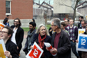 Dick Moran, Elaine Scarry, and Byron Davies march toward Massachusetts Hall